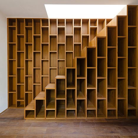 wall-length bookcase extending stairs