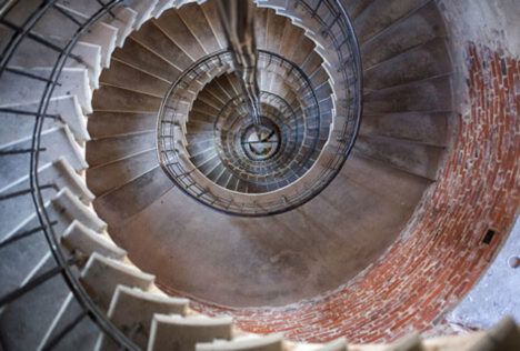 Old brick and stone metal spiral staircase