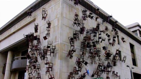 doris salcedo chairs on a building facade