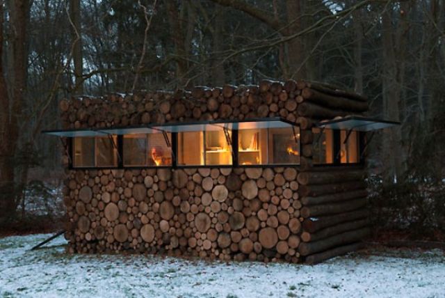 Piet Hein Eek Camouflaged Log Cabin after dark