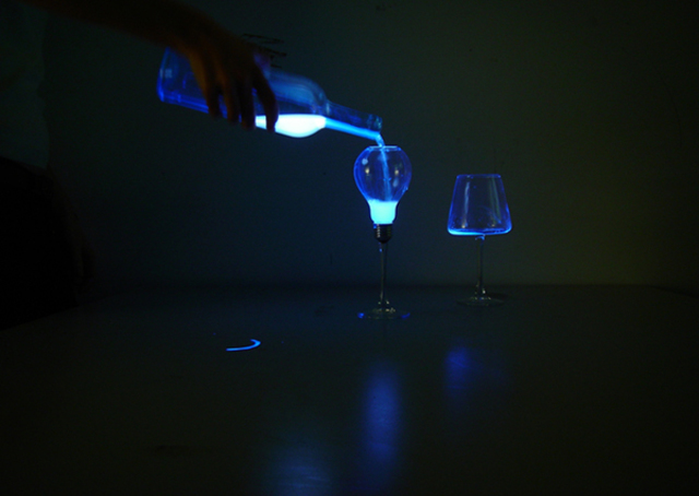 Unusual liquid light design pouring into a glass