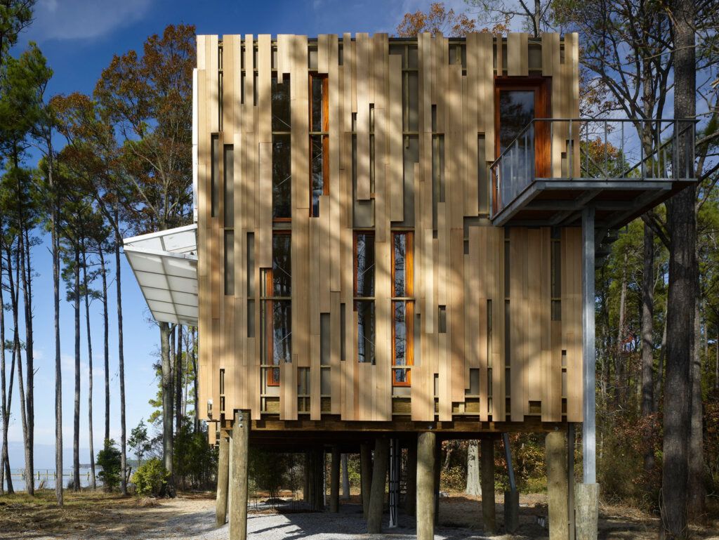 Prefab beach house on stilts wood facade
