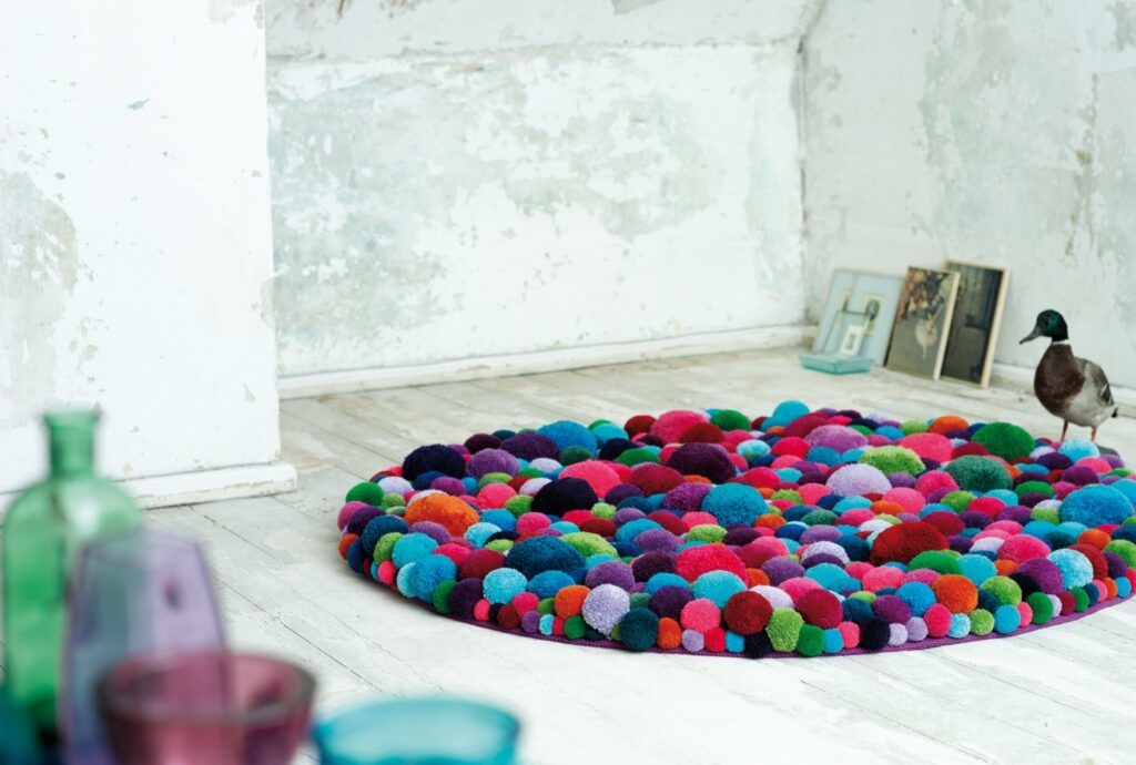 Pom-Poms Make Colorful Rugs, Chairs & Poufs