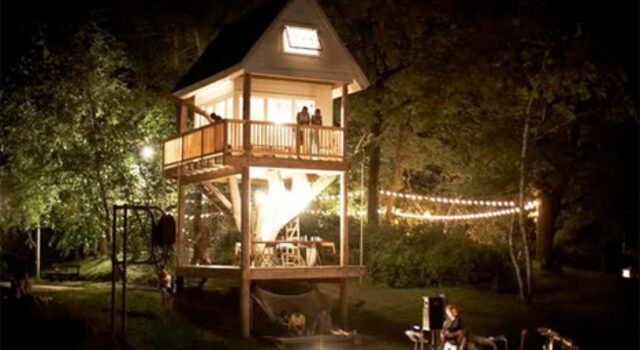 Two story tree house at night