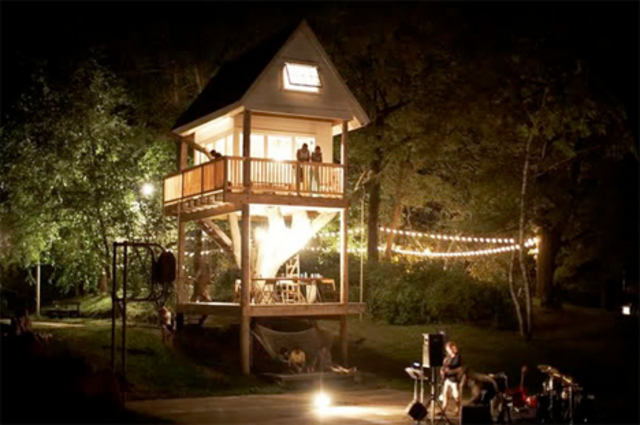 Two story tree house at night