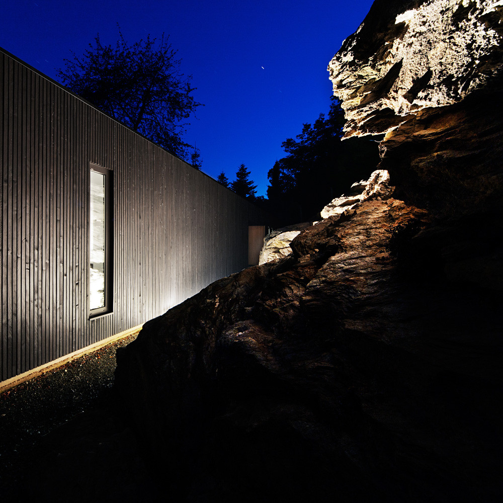 Modern cabin in a quarry rock wall