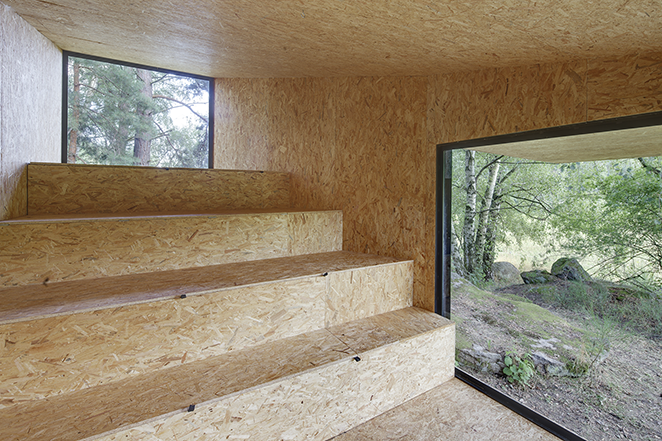 modern forest hut black interior stairs