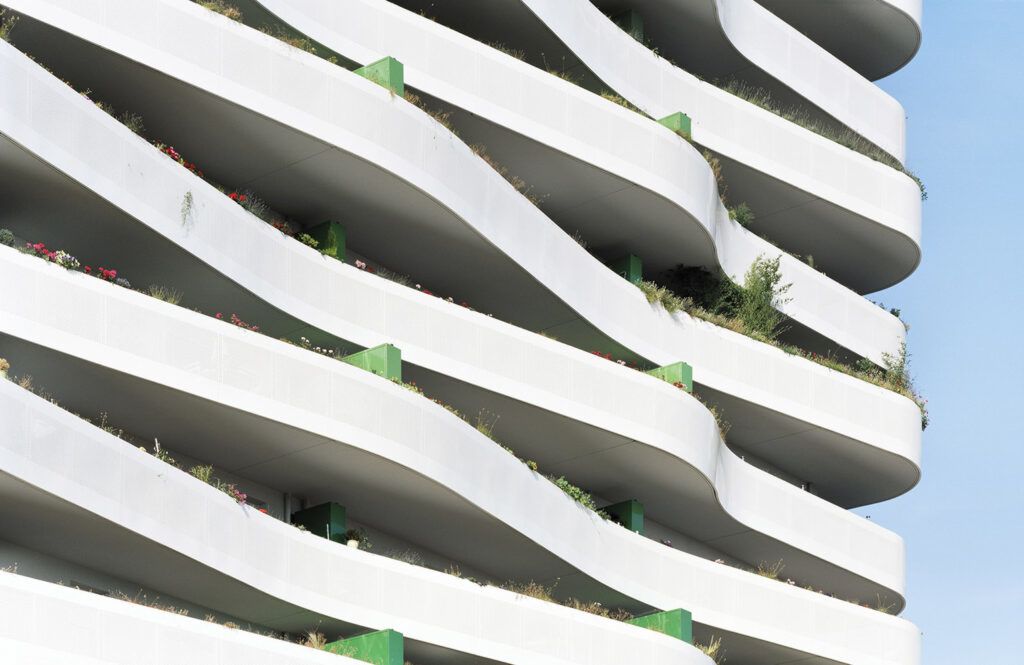 Wavy apartment building balconies with greenery
