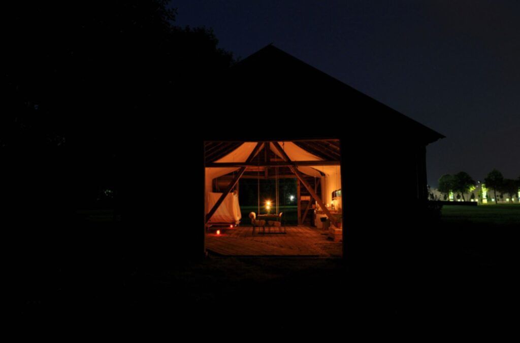 Low cost reclaimed barn residence at night