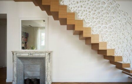 White sculptural staircase railing and room screen