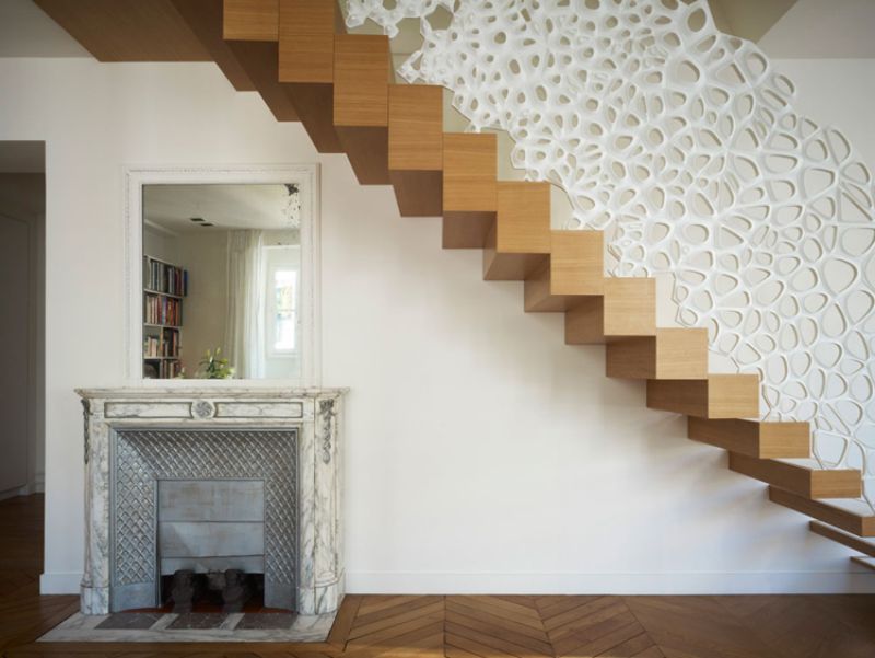 White sculptural staircase railing and room screen