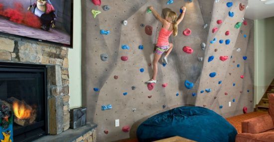 A residential climbing wall inside a Utah rental home