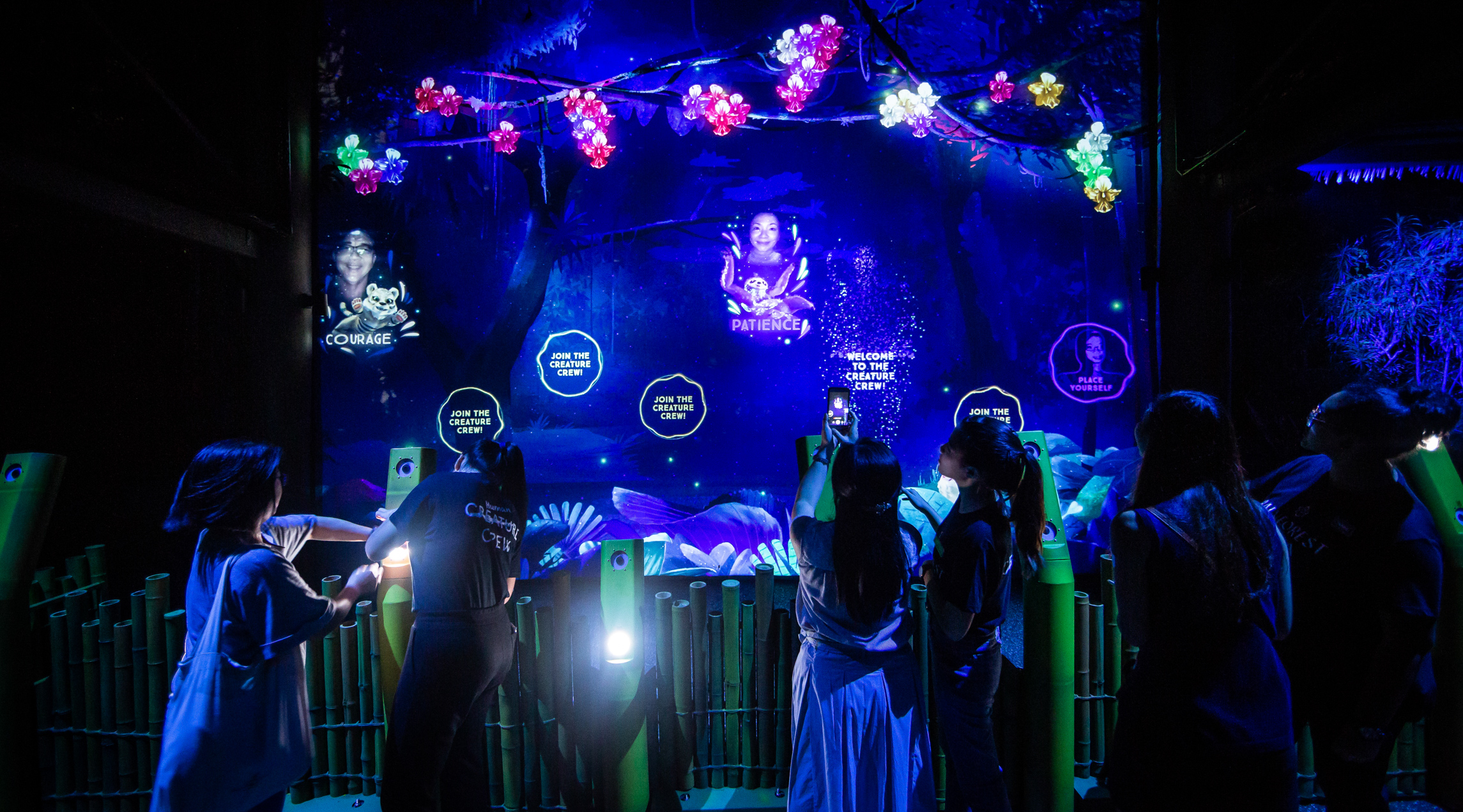 Spectators enjoying the "Rainforest Lumina" multisensory experience at the Singapore Zoo,