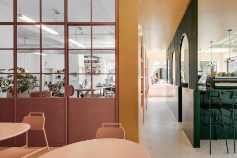 A view of the Cafe Rita in Montreal with color blocked spaces in pink and green. 