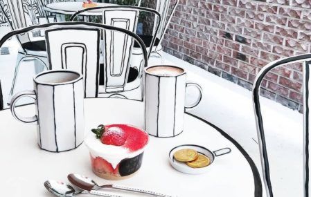 Two black and white mugs on a table inside the Café Yeonnam-dong.