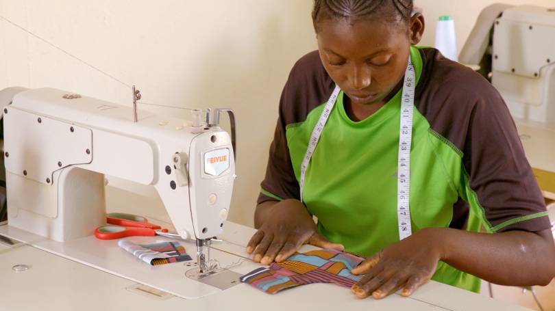 A Kenyan seamstress making reusable sanitary pads as part of ASOS' new "Kujuwa Initiative."