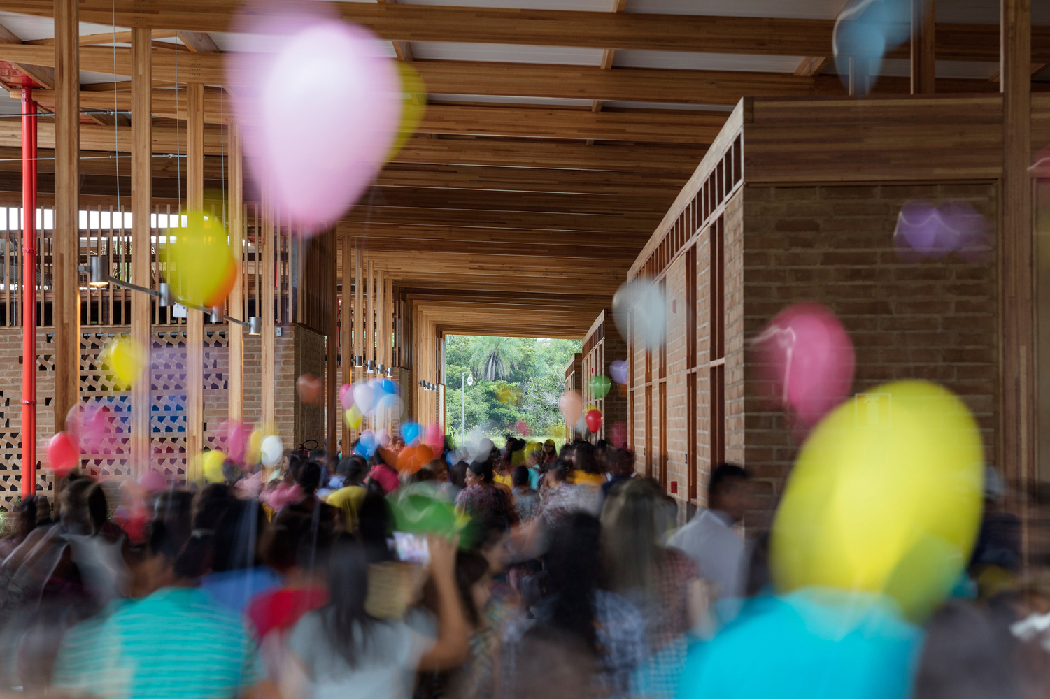 A corridor packed will kids and balloons inside the Children's Village School. 