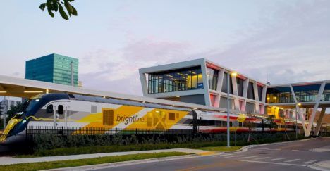 A Brightline high-speed train pulling into a station.