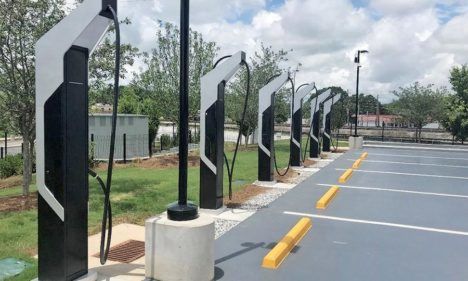 Porsche's new EV charging stations lined up in front of several parking spots.