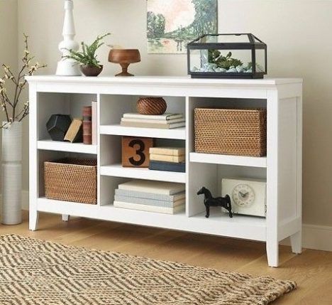 A low, white Threshold shelving unit set up in a home.