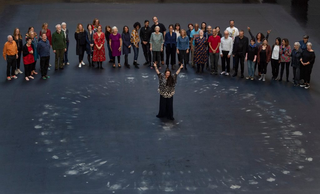 People standing on the heat-sensitive floor featured in Tania Bruguera's new interactive installation, "10,145,196."