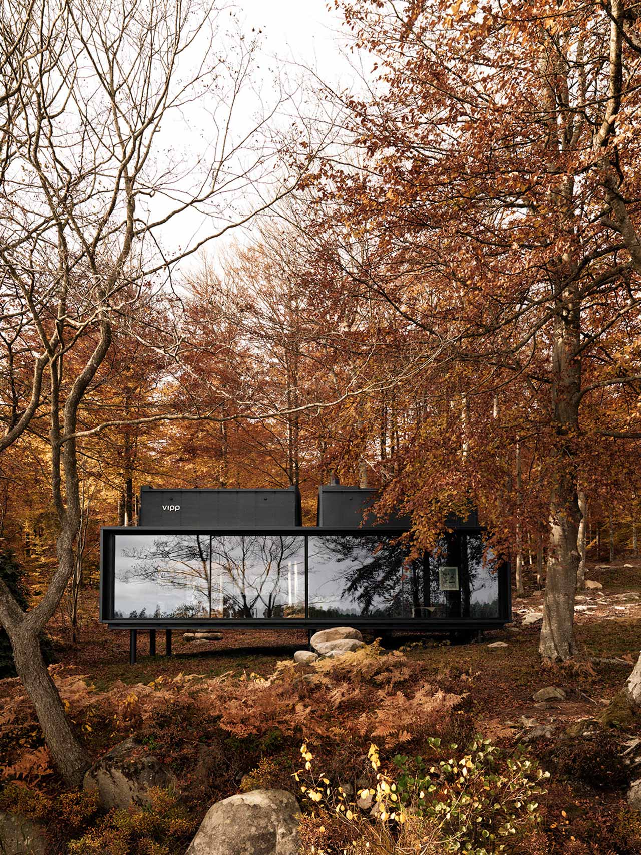 Vipp's "Shelter" prefab home situated in a woodland area. 
