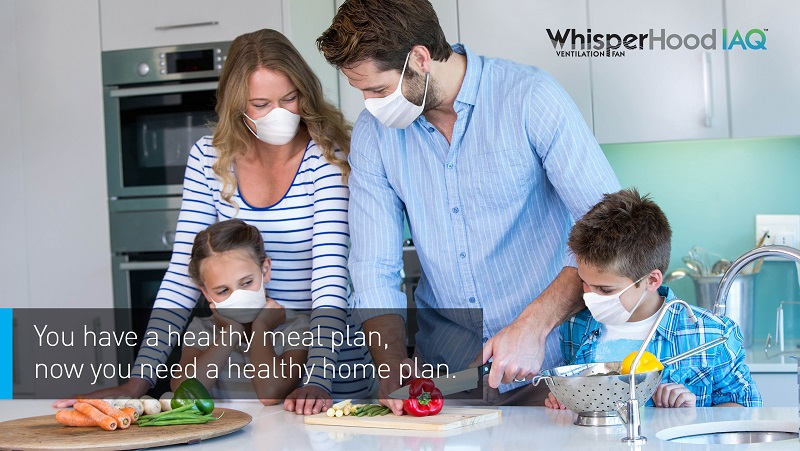 Promotional image for Panasonic's new Whisperhood IAQ, depicting a family chopping veggies in their kitchen while wearing white surgical masks.