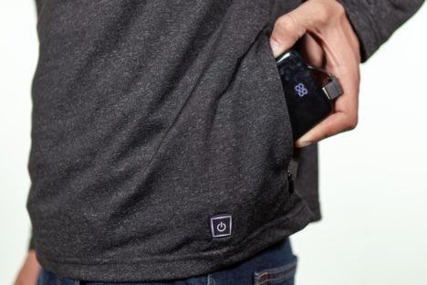 Someone removing the Flare shirt's power bank from a conspicuous side pocket.