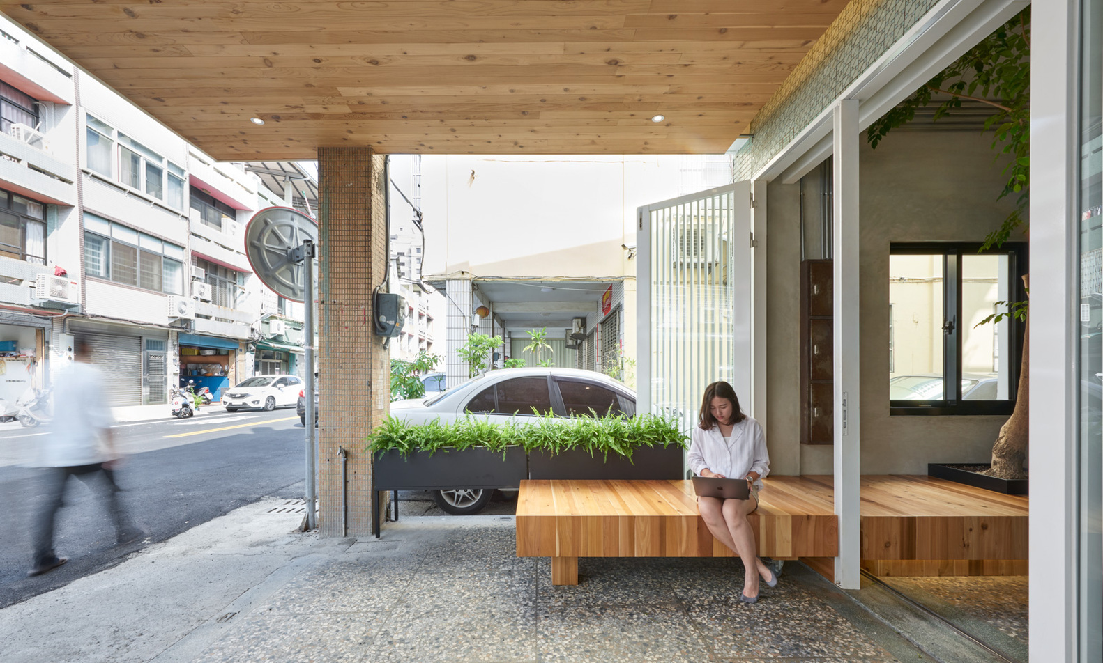 The movable wooden bench at the Corner 60's entryway. 