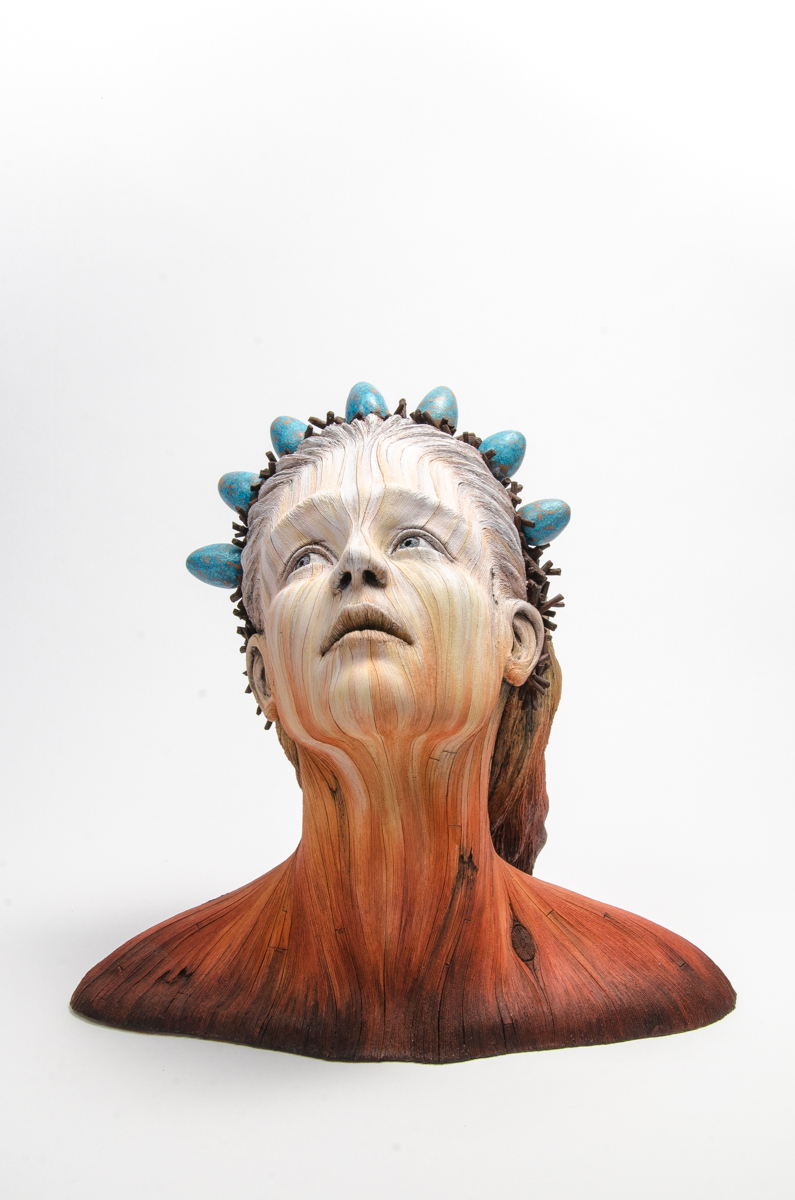 A ceramic sculpture by Christopher David White, this one depicting the bust of a woman with a small crown on her head. 