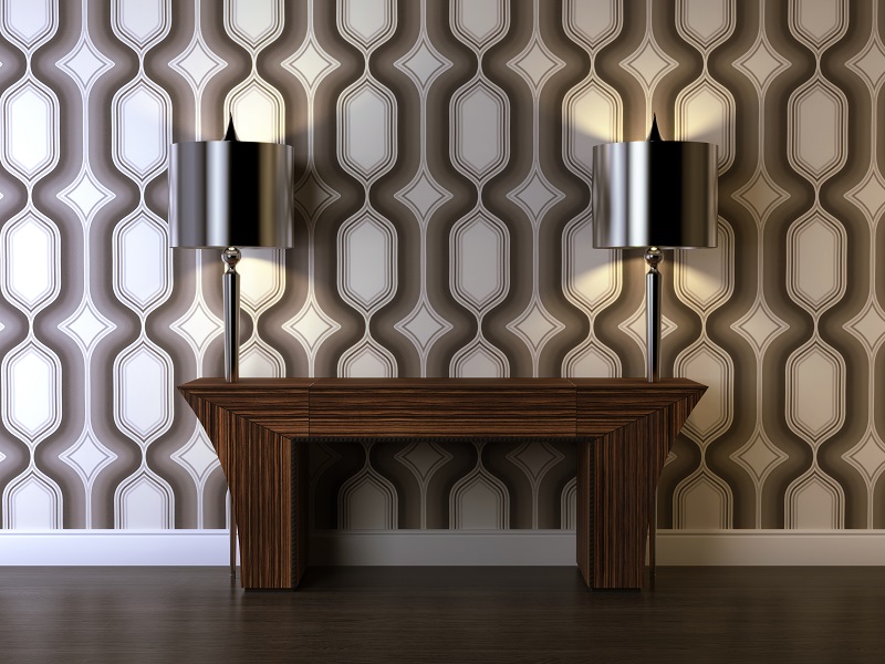 A small slice of an Art Deco decor scheme, featuring two steel lamps, a nightstand, and vintage wallpaper.