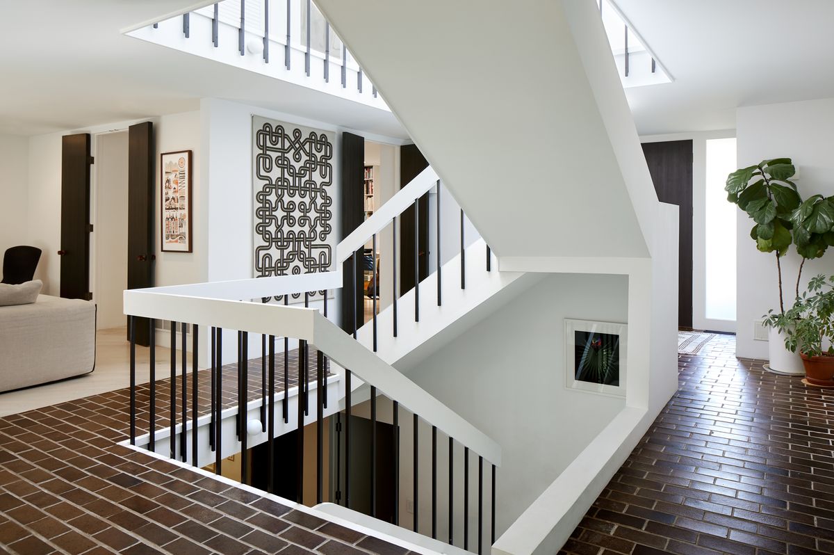The central staircase inside the Grawe family's renovated 1970s dream home. 