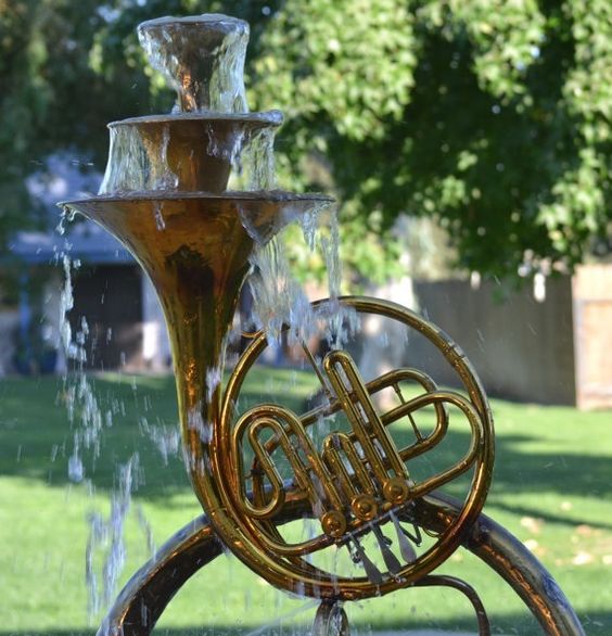 An old French horn upcycled into a functional outdoor fountain. 