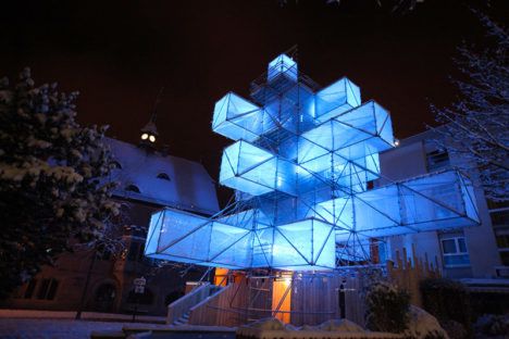 Belgium's ultramodern Christmas tree glowing blue in the night.