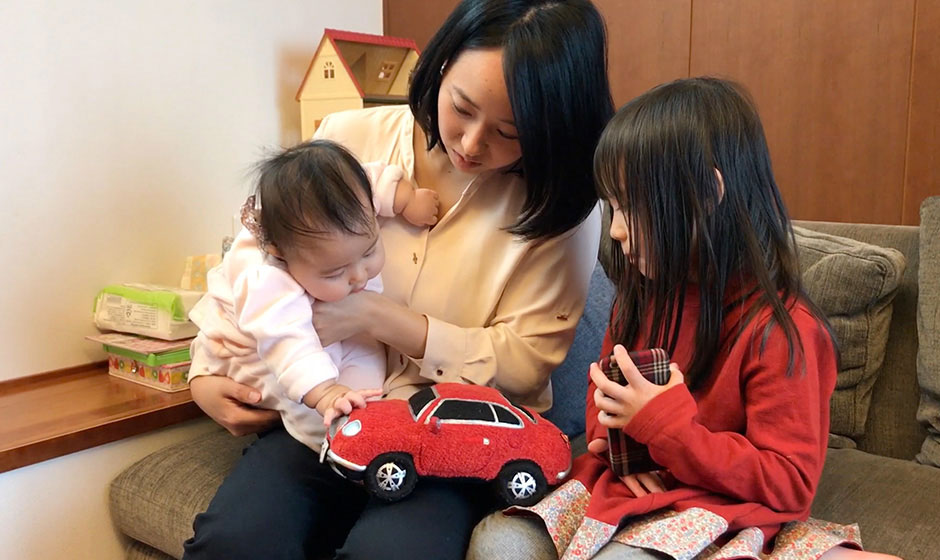 Mom and her two children playing with the new Honda Sound Sitter stuffed toy.