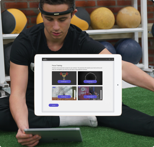 Young man tries out BrainCo's FocusFIT fitness headband and accompanying tablet app. 