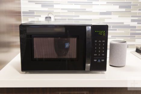 The AmazonBasics Microwave resting on a kitchen counter.