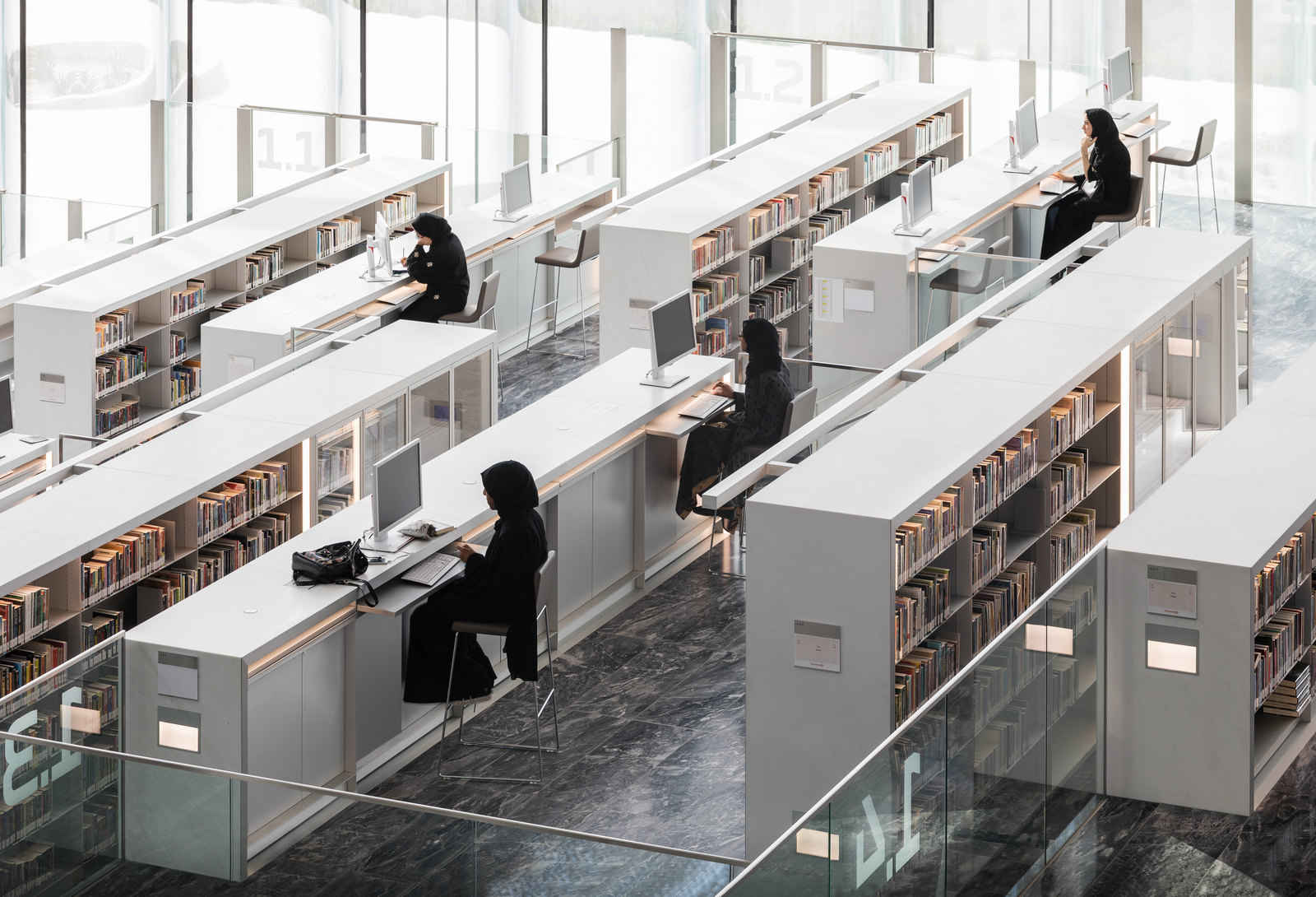 People working on desktop computers inside the new Qatar National Library.