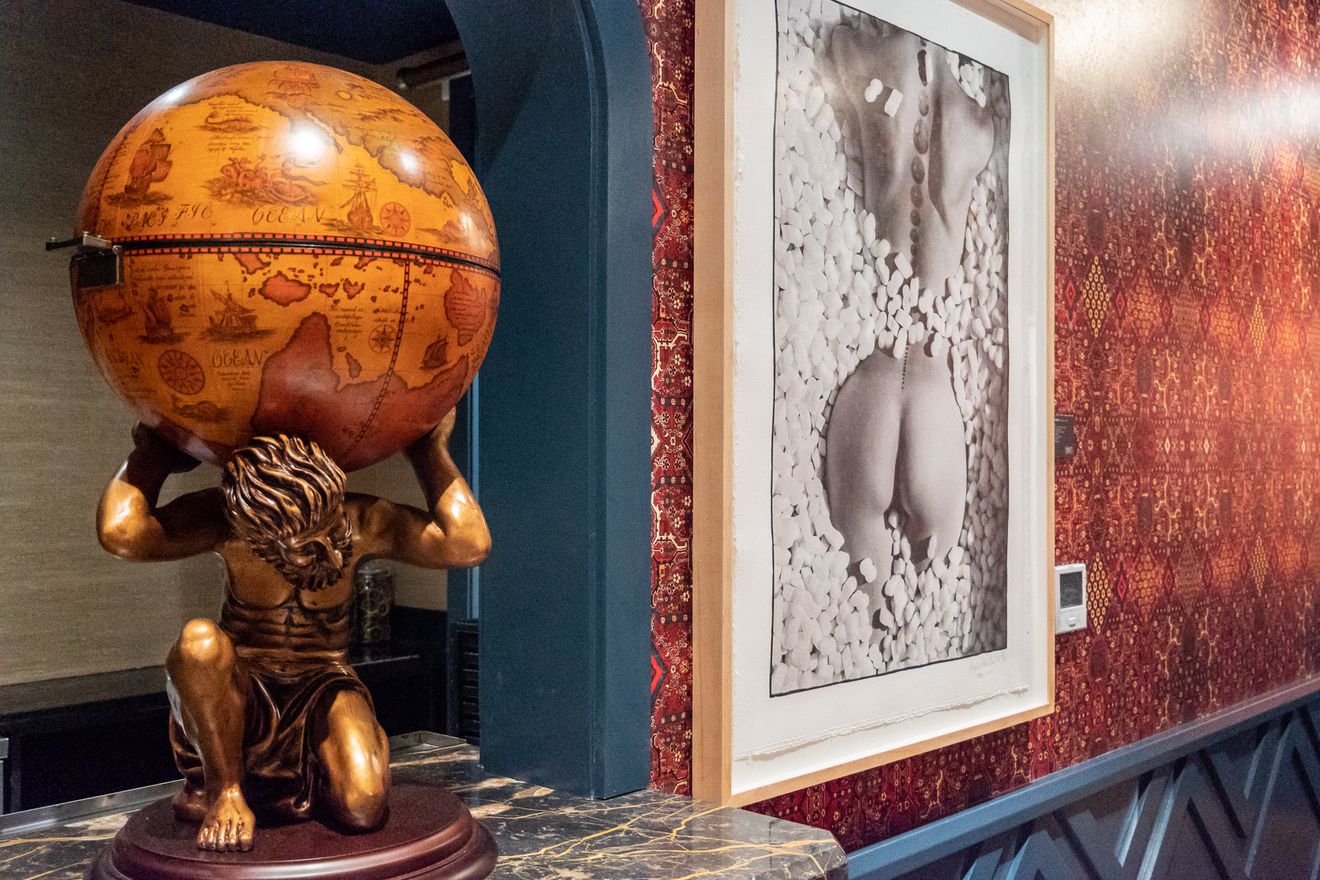 A statue of Atlas holding up the globe - just one of many art pieces sprinkled throughout Bar Bevy.