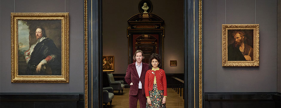 Director Wes Anderson and partner Juman Malouf standing in the entryway to their new exhibit in Vienna's Kunsthistorisches Museum.