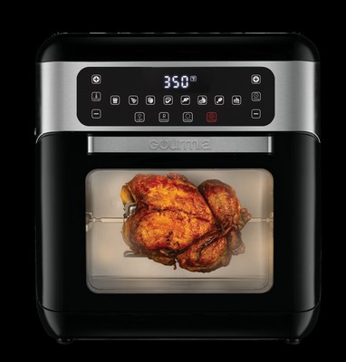 Gourmia's smart new air fryer against a black backdrop, with a chicken cooking inside.