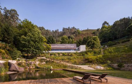 The Gerês House's lower wooden deck and pond area, with the house itself visible in the background.