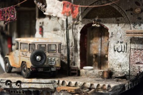 A sculpture by Mohamad Hafez depicting a Jeep in front of a ruined Syrian building.