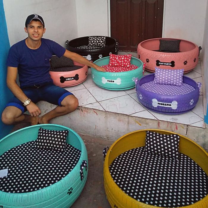 Brazilian craftsman Amarildo Silva sits surrounded by his colorful upcycled dog beds. 