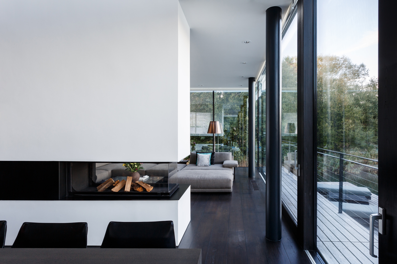A minimalist fireplace and living area inside Mecanoo's new "Villa on the Lake."