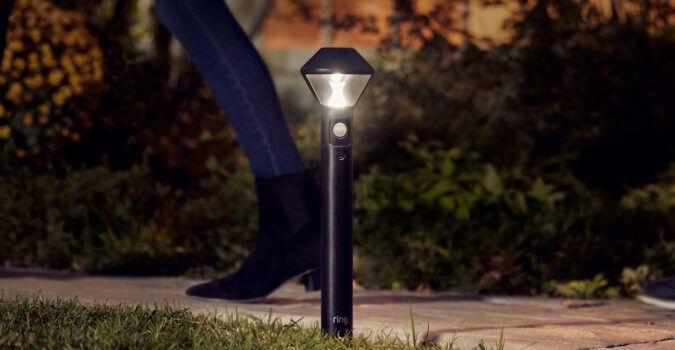 Person walking by a new Ring Pathlight.