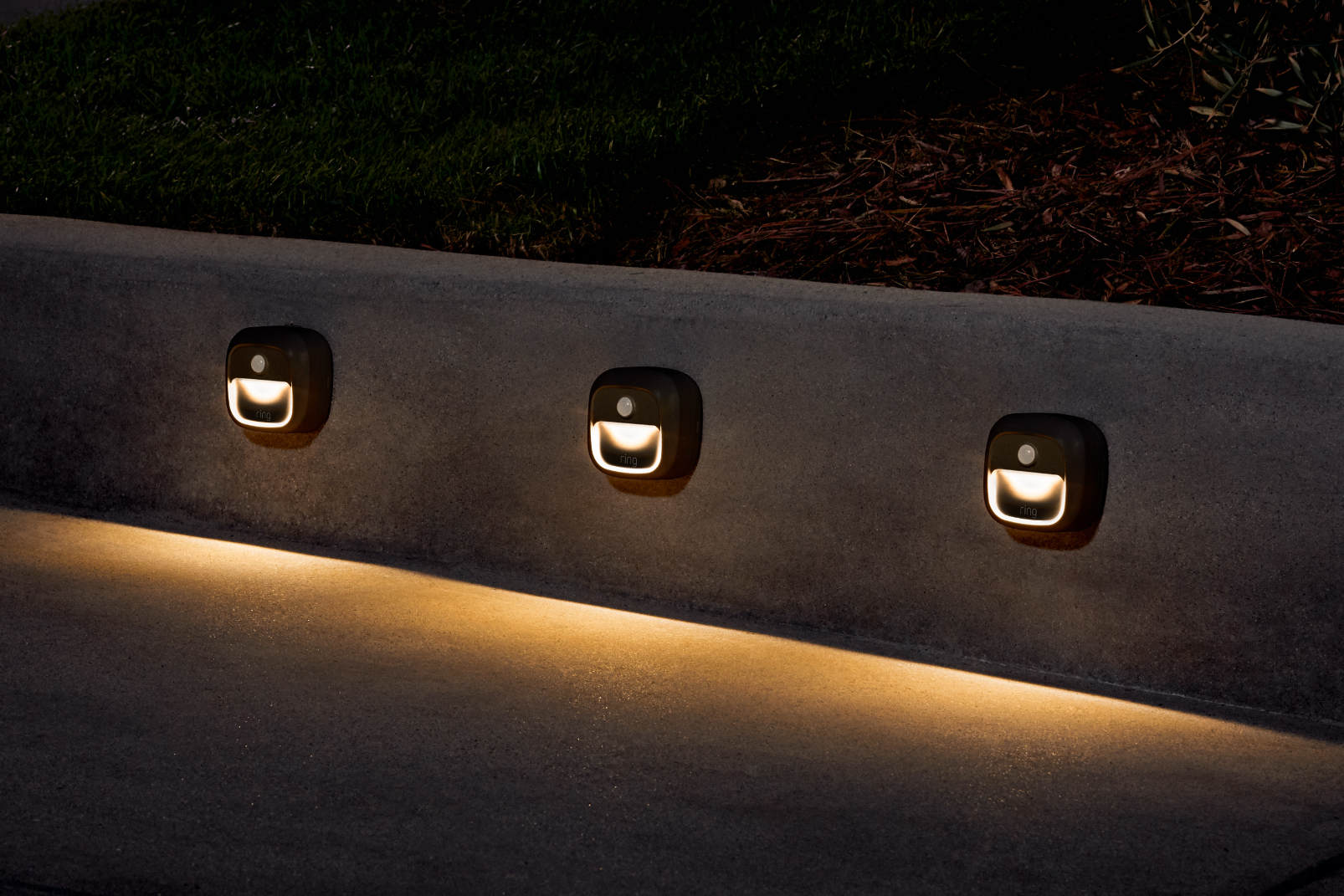 Three Ring Steplights installed along a small outdoor walkway. 