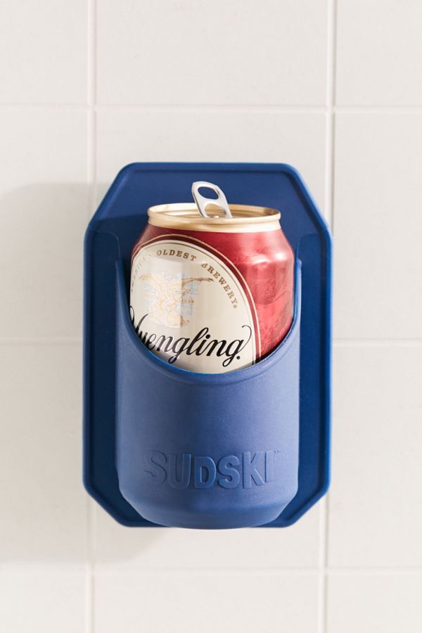 The Sudksi Drink Holder mounted to a shower wall, with a beer can nestled firmly inside it. 