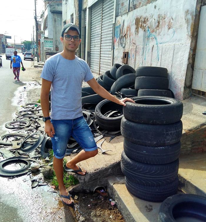 Brazilian craftsman Amarildo Silva stacks up a pile of abandoned tires.