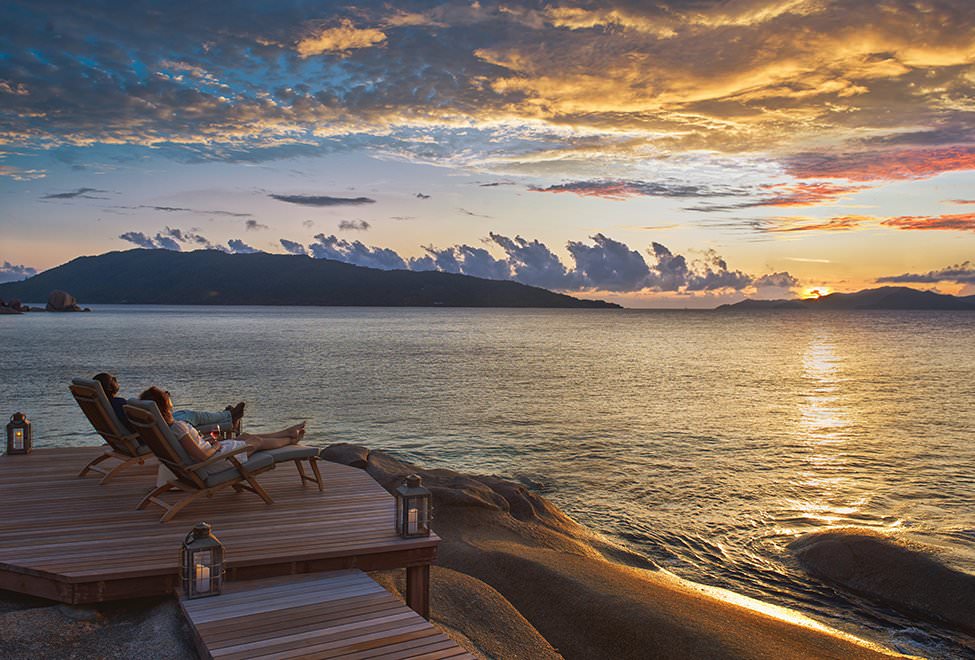 Couple watches the sunset from their private deck at Six Senses Zil Pasyon.